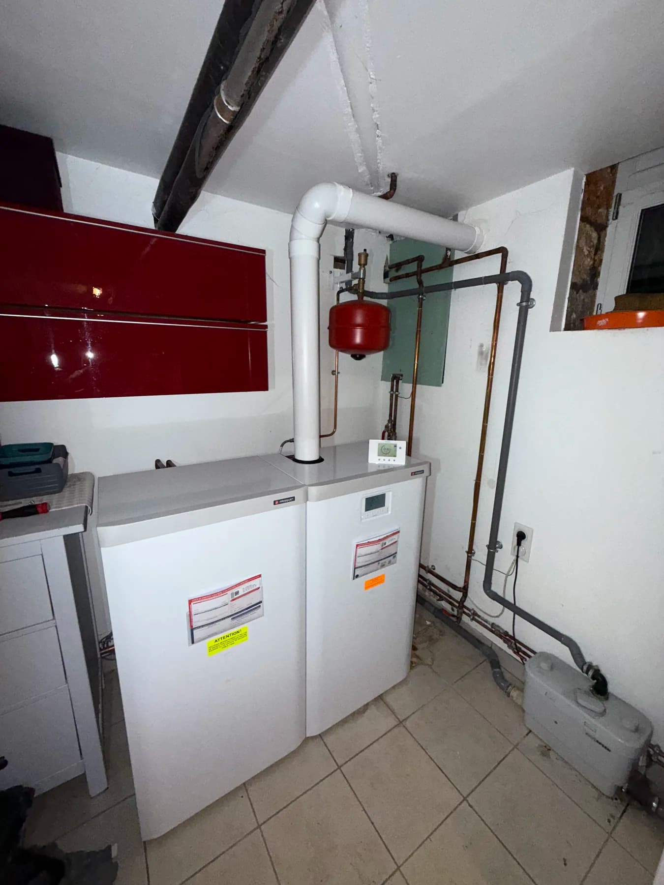 White floor-standing boilers in a technical room
